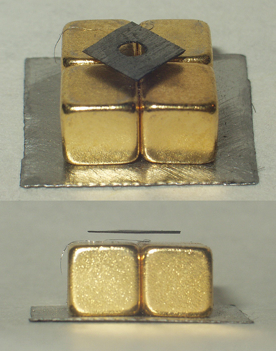  square of graphite levitating above four cubic magnets