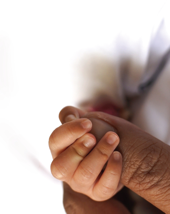 infant grasping onto finger