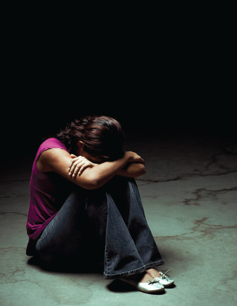 woman hunched over legs